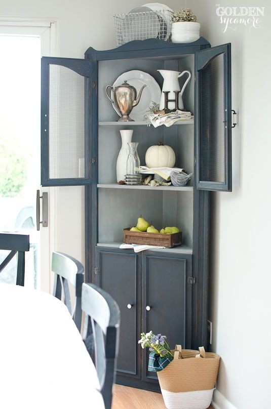 Charming Blue Corner Cabinet with Rustic Accents