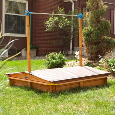 Large covered wooden sandbox gives excellent outdoor fun