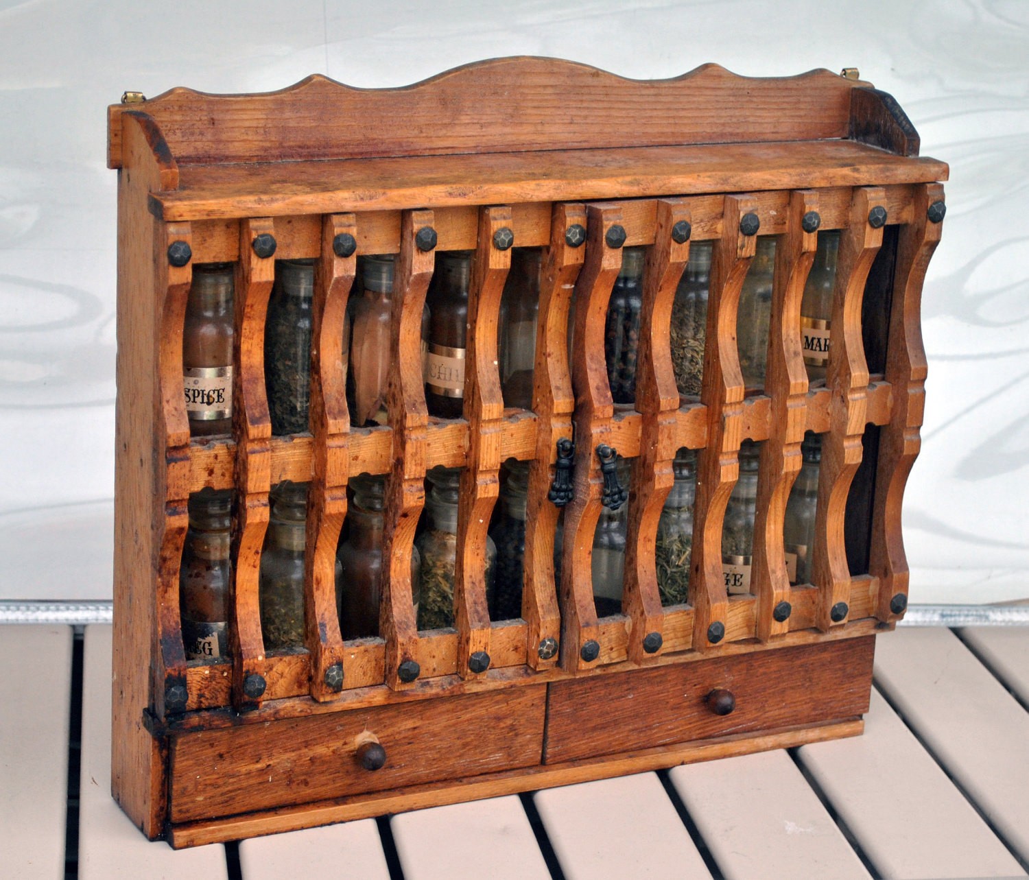 Vintage wall mounted spice rack cabinet with glass bottles