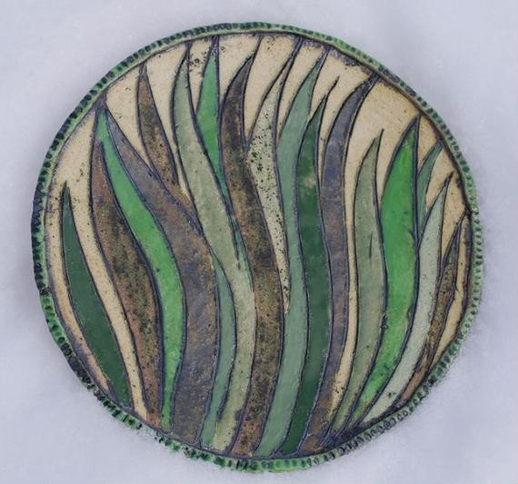 A large decorative plate on the wall grass