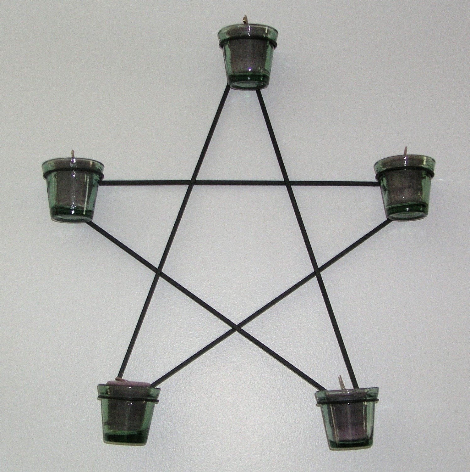 Black wrought iron wall mounted candle holder star