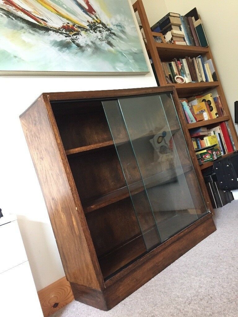 Old dark wooden bookcase with glass doors in cheltenham