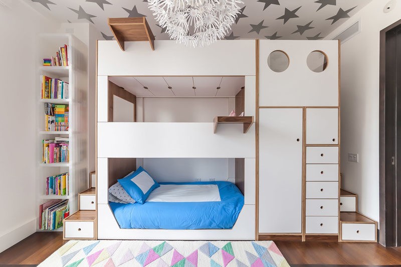 This triple bunk bed was designed with storage and stairs