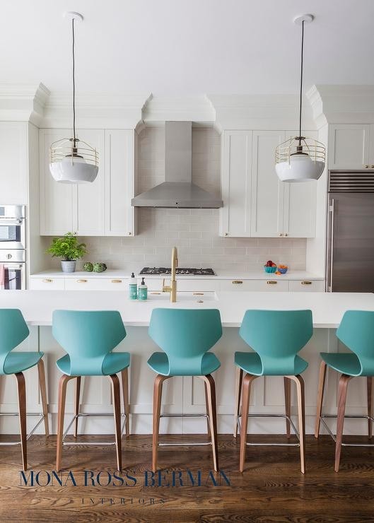 White kitchen with modern turquoise counter stools