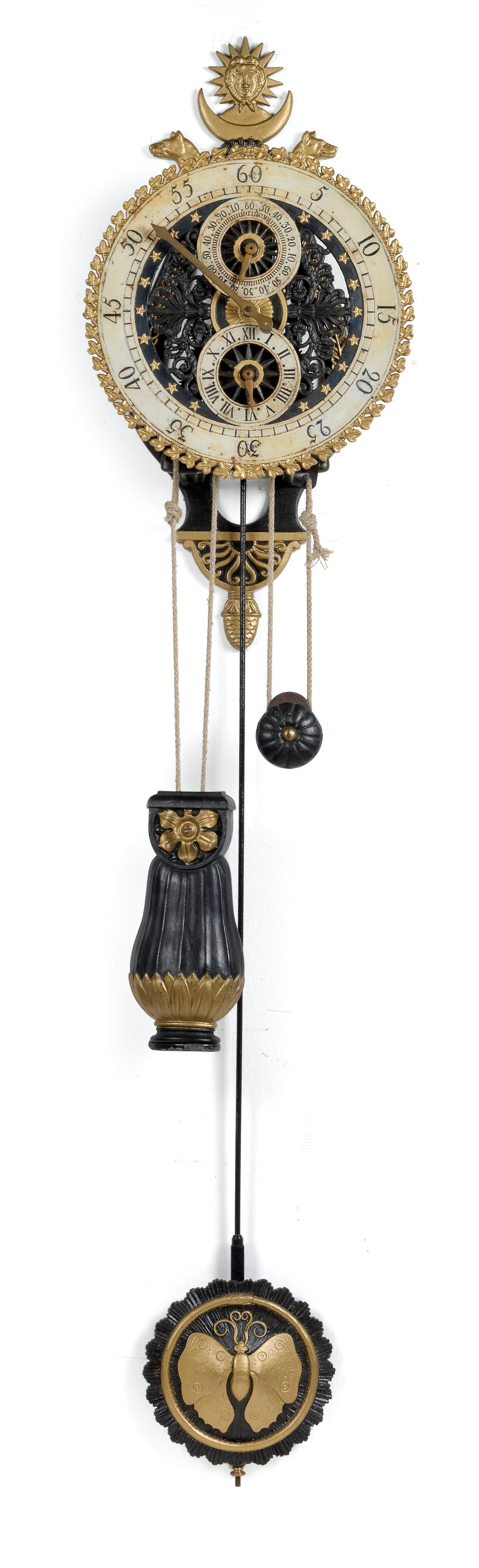A cast iron wall pendulum clock from the french provinces