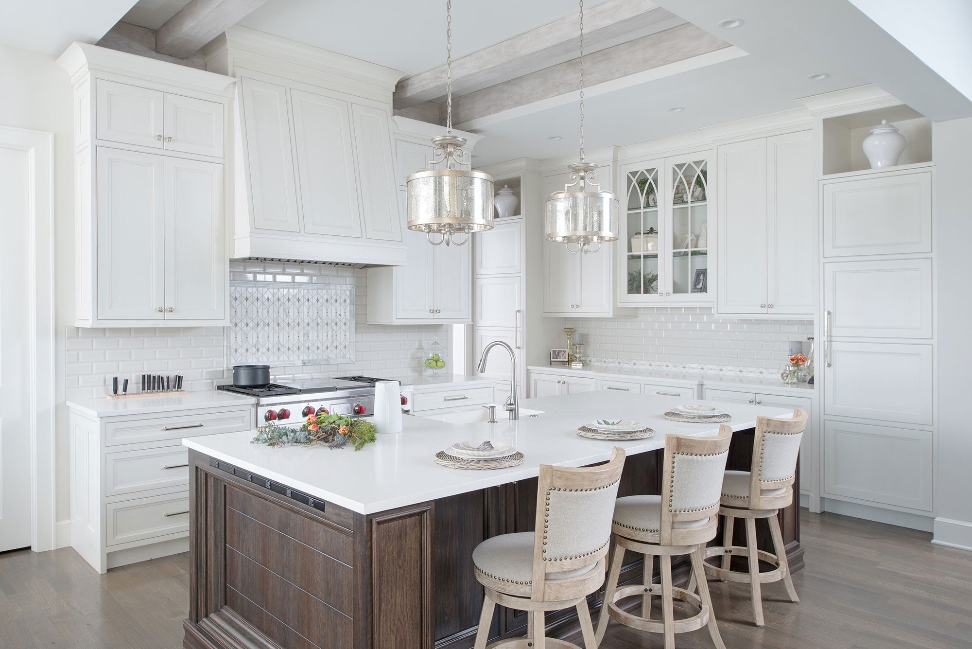 Painted white kitchen with dark wood island crystal cabinets