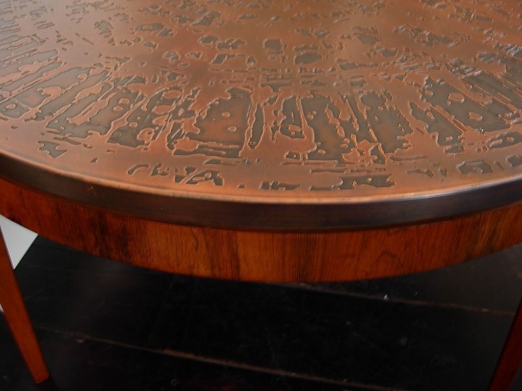 Simple round copper coffee table with hammered round