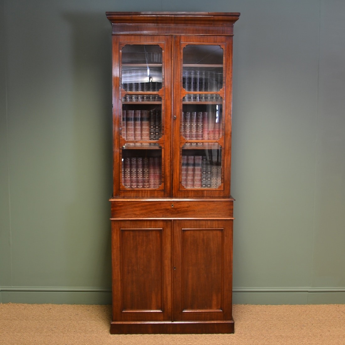 Tall slim victorian mahogany antique bookcase on cupboard