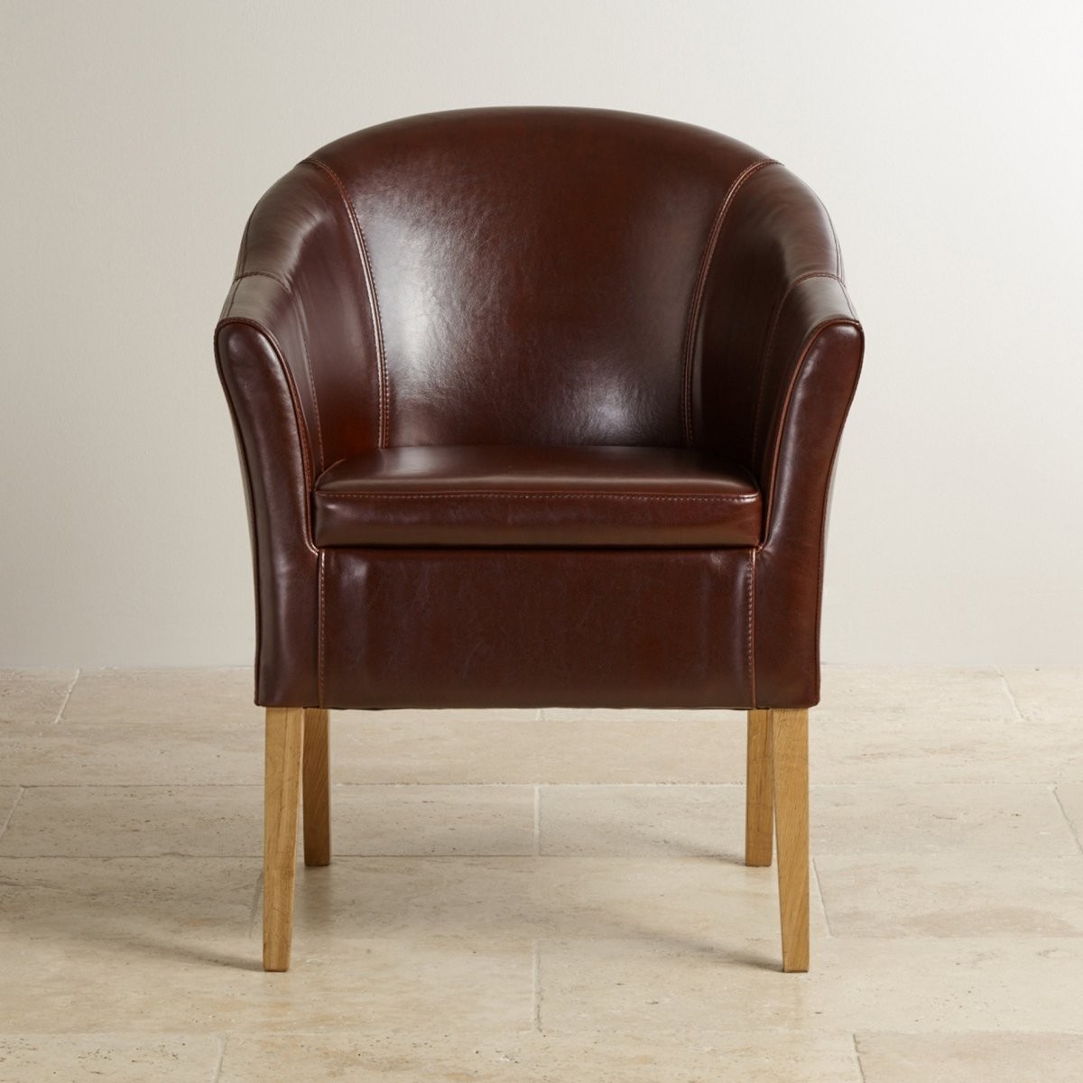 Brown leather tub chair with solid oak legs oak