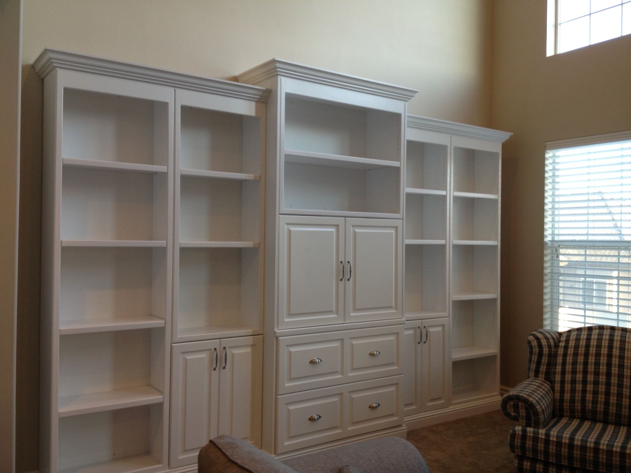 White entertainment center with pockets doors and