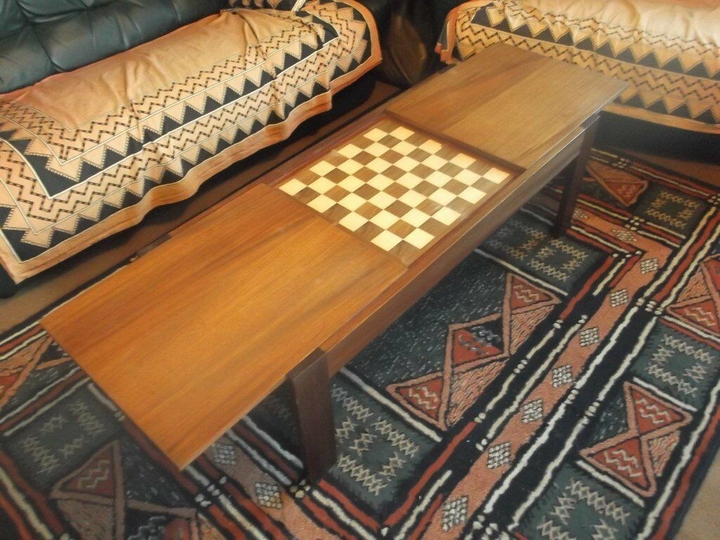 Dark wood coffee table containing hidden chess board in