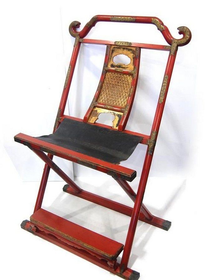 A japanese red lacquer priest folding chair with a leather