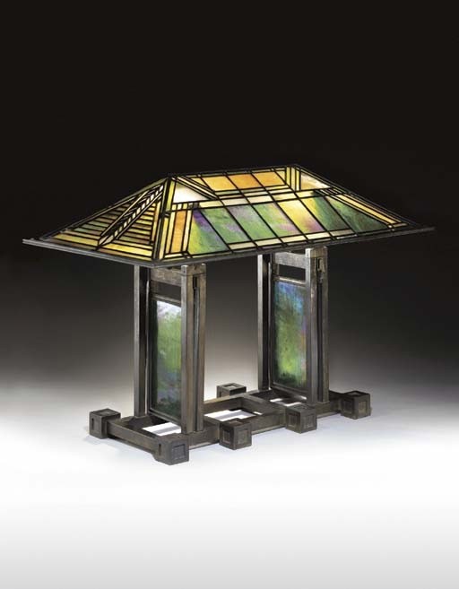 An important leaded glass and bronze table lamp frank