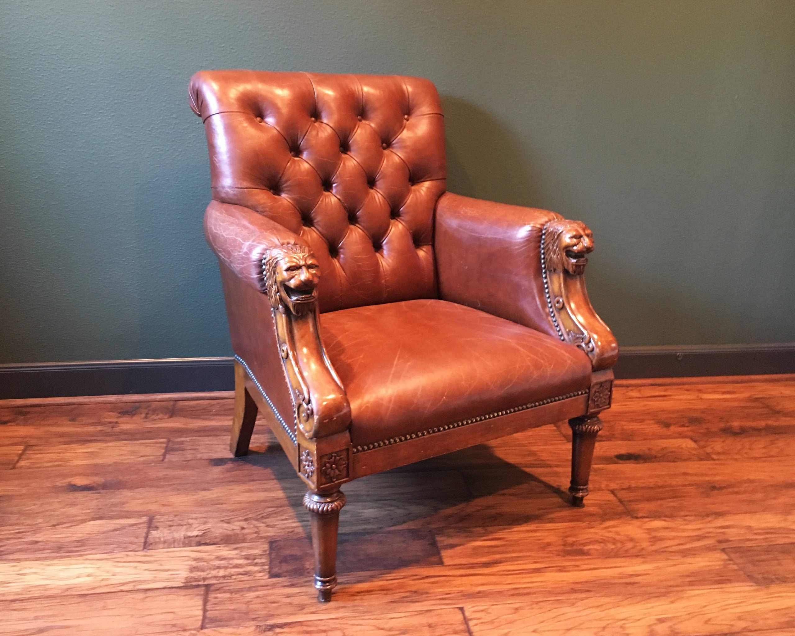 Antique leather chesterfield chair with lion head arms