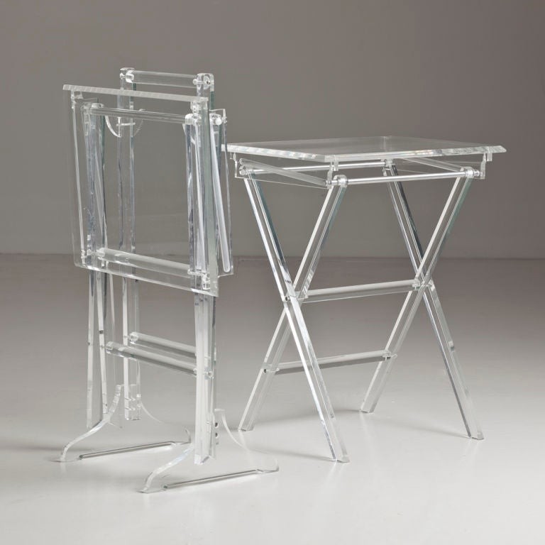 A pair of folding lucite tray tables with stand at