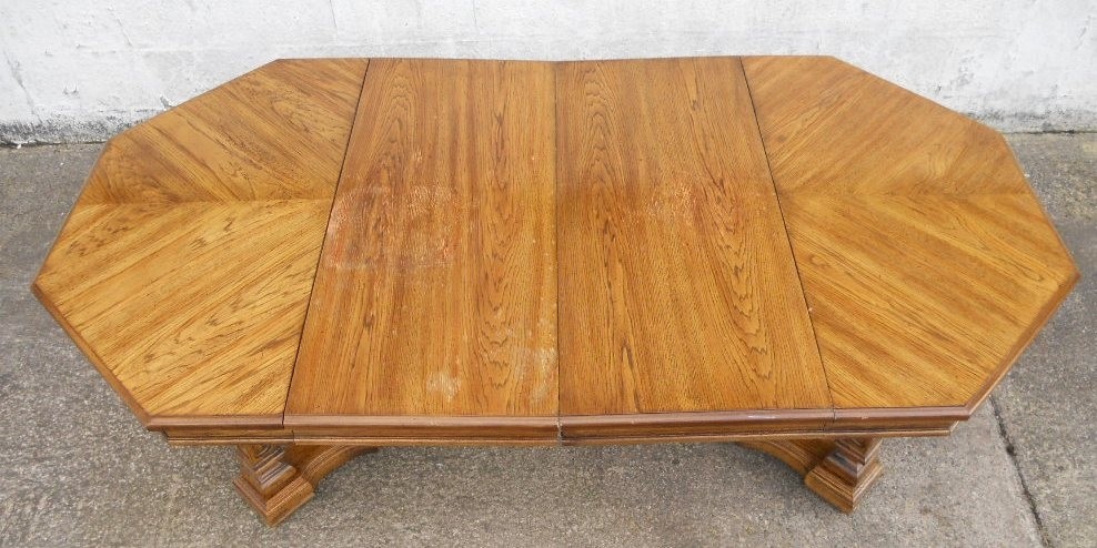 Octagonal light oak extending pedestal dining table to 1