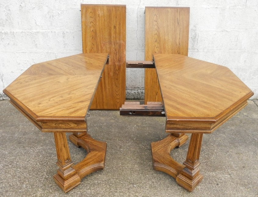 Octagonal light oak extending pedestal dining table to