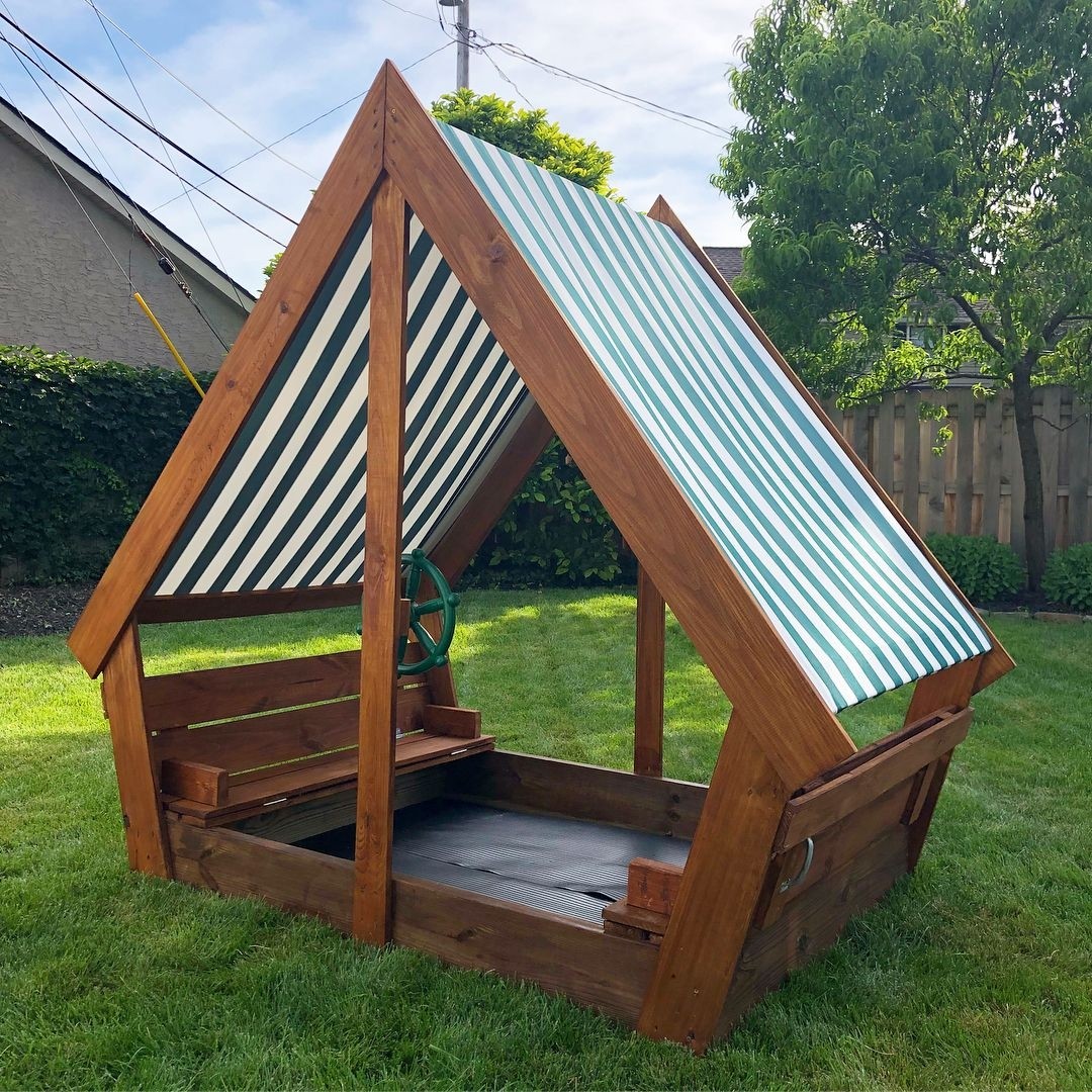 Diy wooden sandbox with waterproof overhang covered to