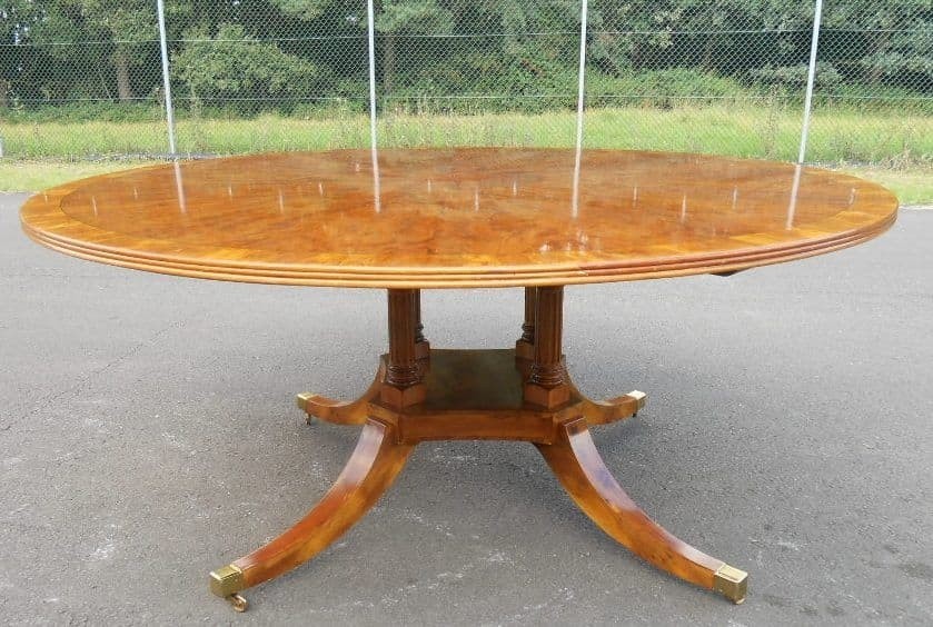 Large yew wood circular pedestal dining table to seat ten
