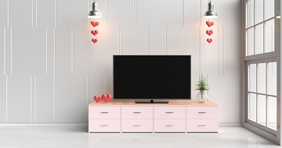 Smart tv on pink tv stand in white living room