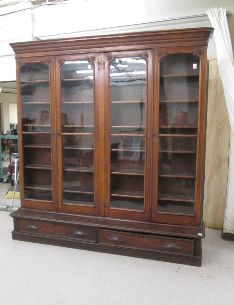 A large victorian four door walnut cabinet bookcas