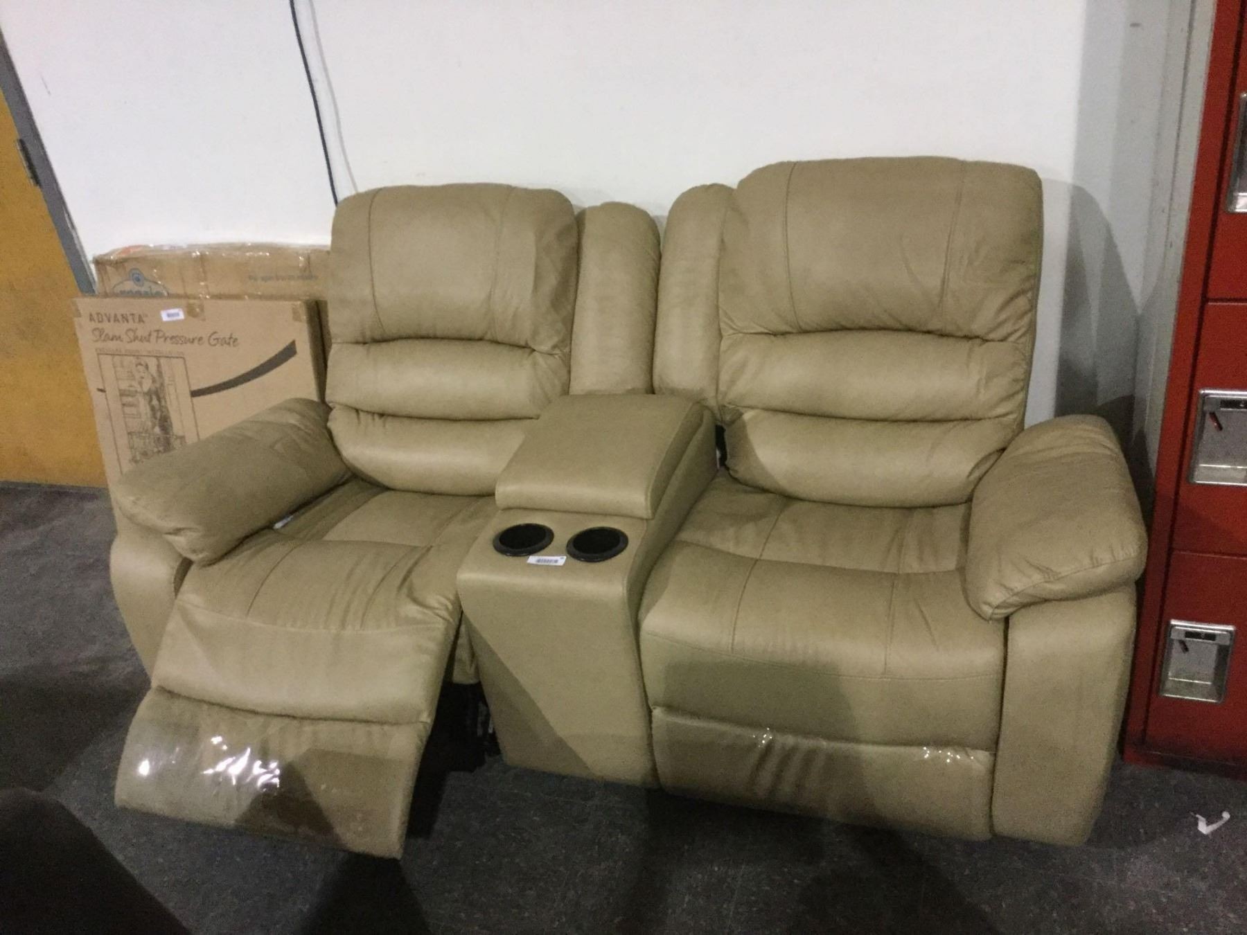 Beige leather reclining loveseat w cup holders