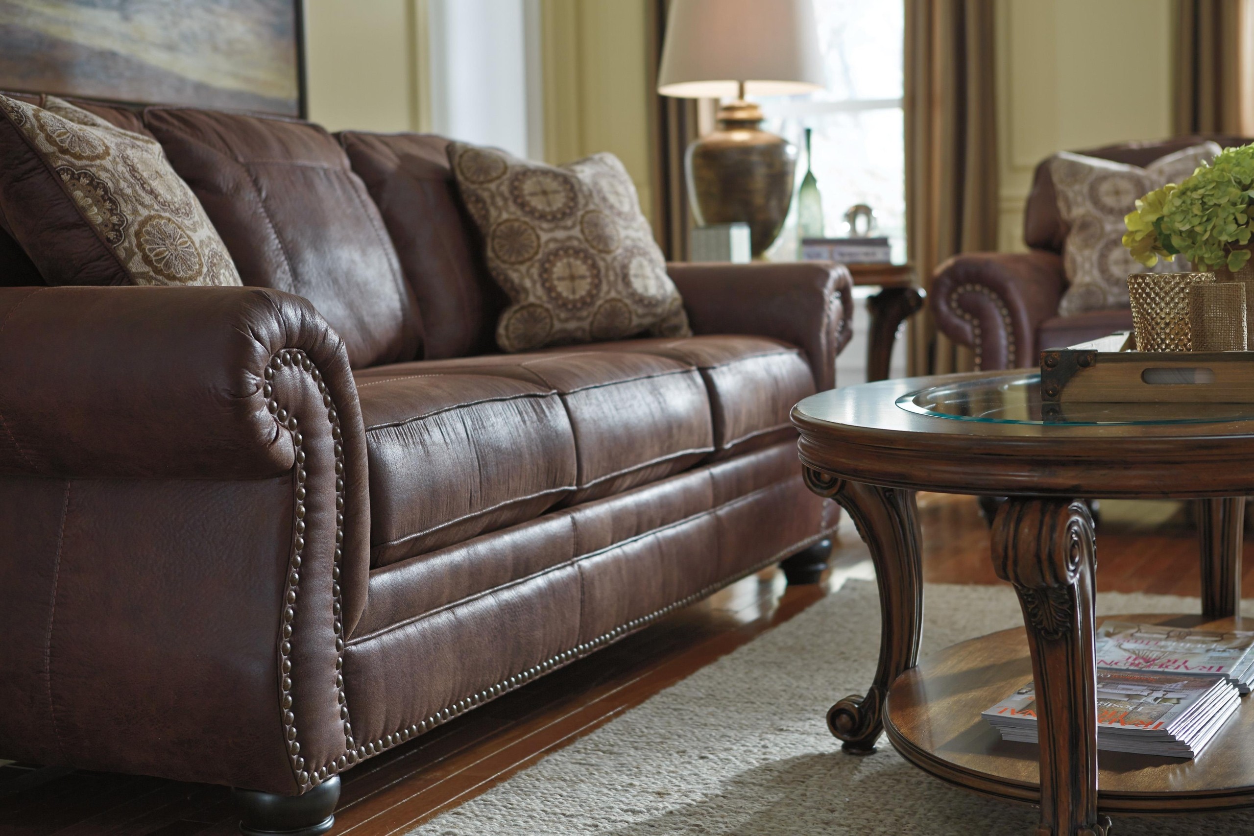Benchcraft breville faux leather sofa with rolled arms and