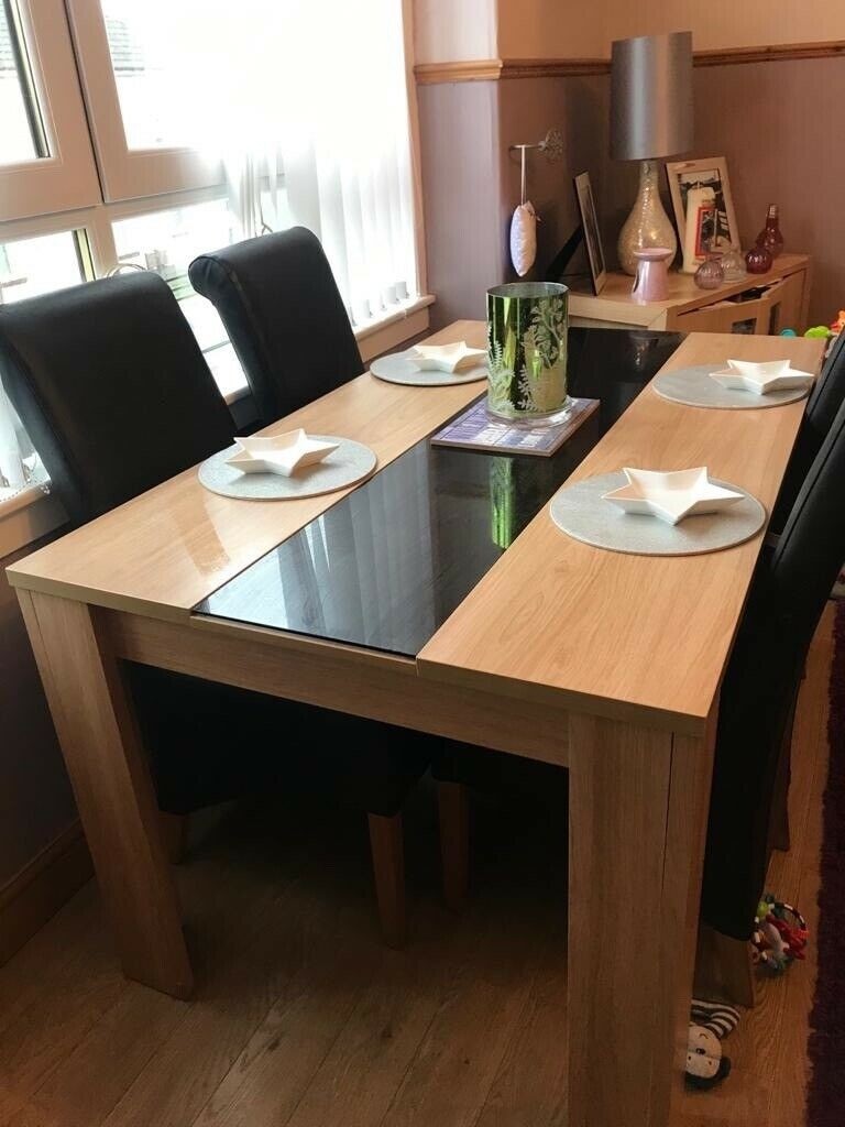 Large oak wood rectangular dining table with a black glass