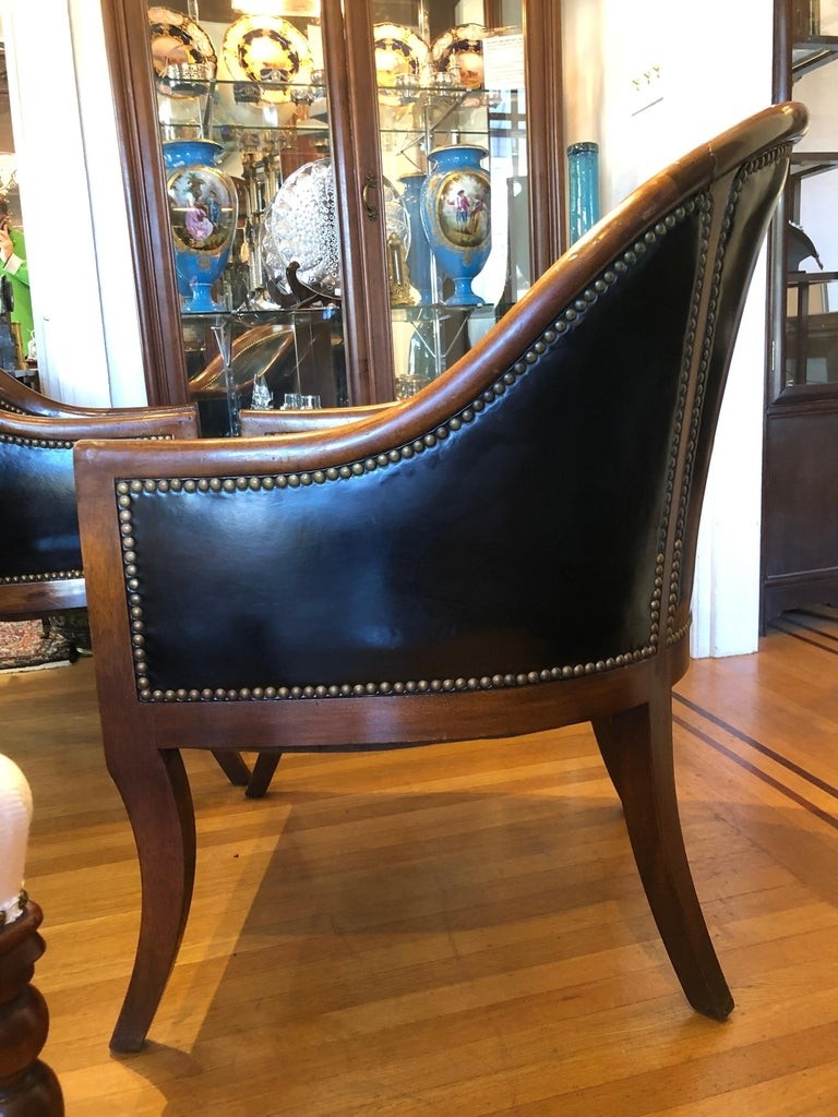 Pair of black leather and mahogany club barrel side