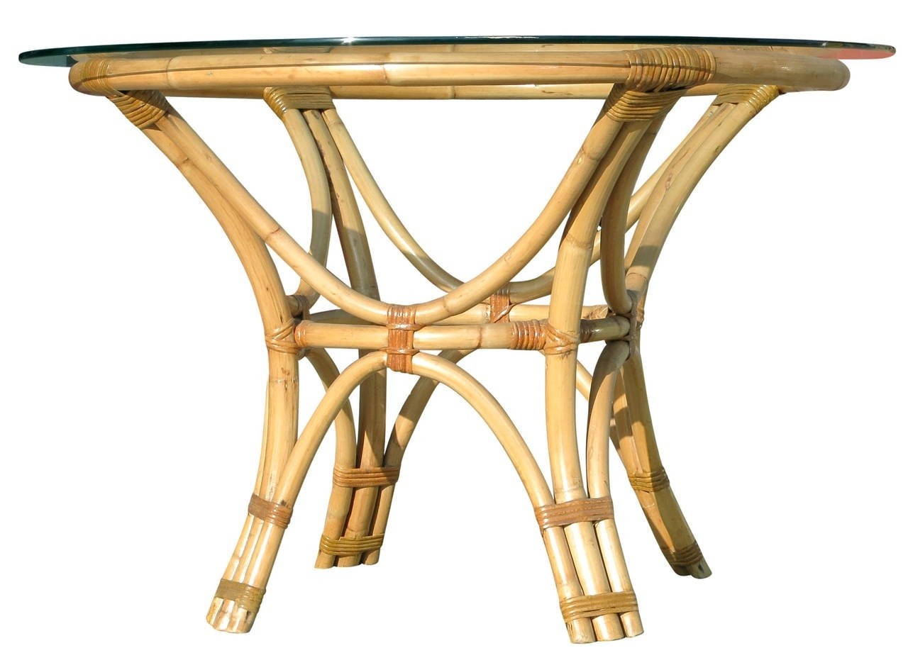 Rattan bent wood dining table with round glass top at