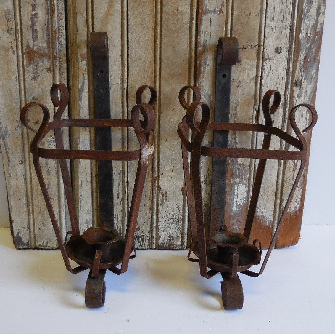 Two vintage hanging candle holders wrought iron wall mount
