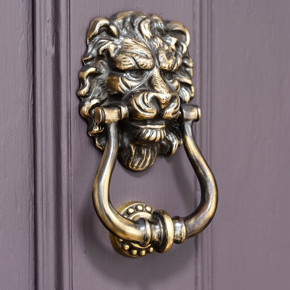 Aged brass lions head door knocker