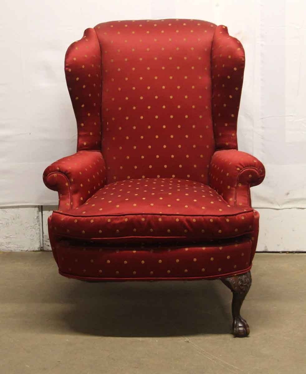 Antique red upholstered arm chair with carved wooden legs 1