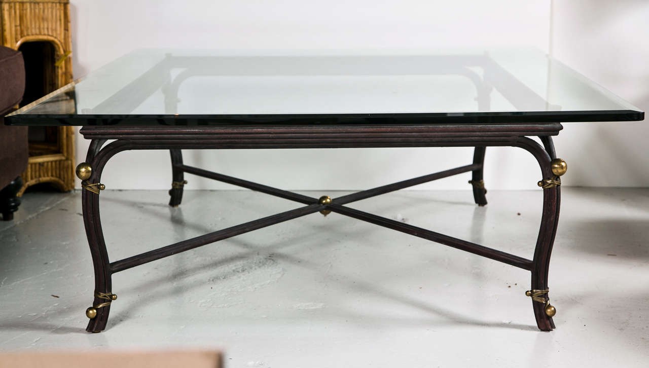 Large bronze base coffee table with beveled glass top at