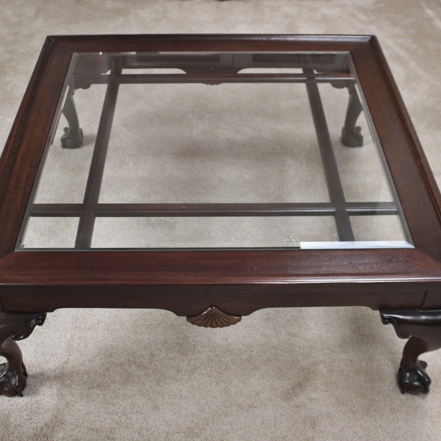 Large cherry glass top coffee table with carved claw feet