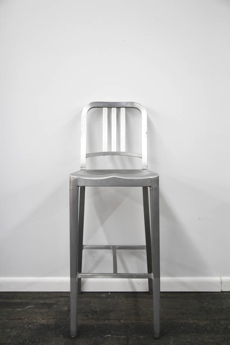Pair of emeco navy counter stools in brushed aluminum at