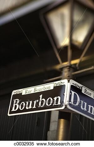 A lamp post with a sign for bourbon street from