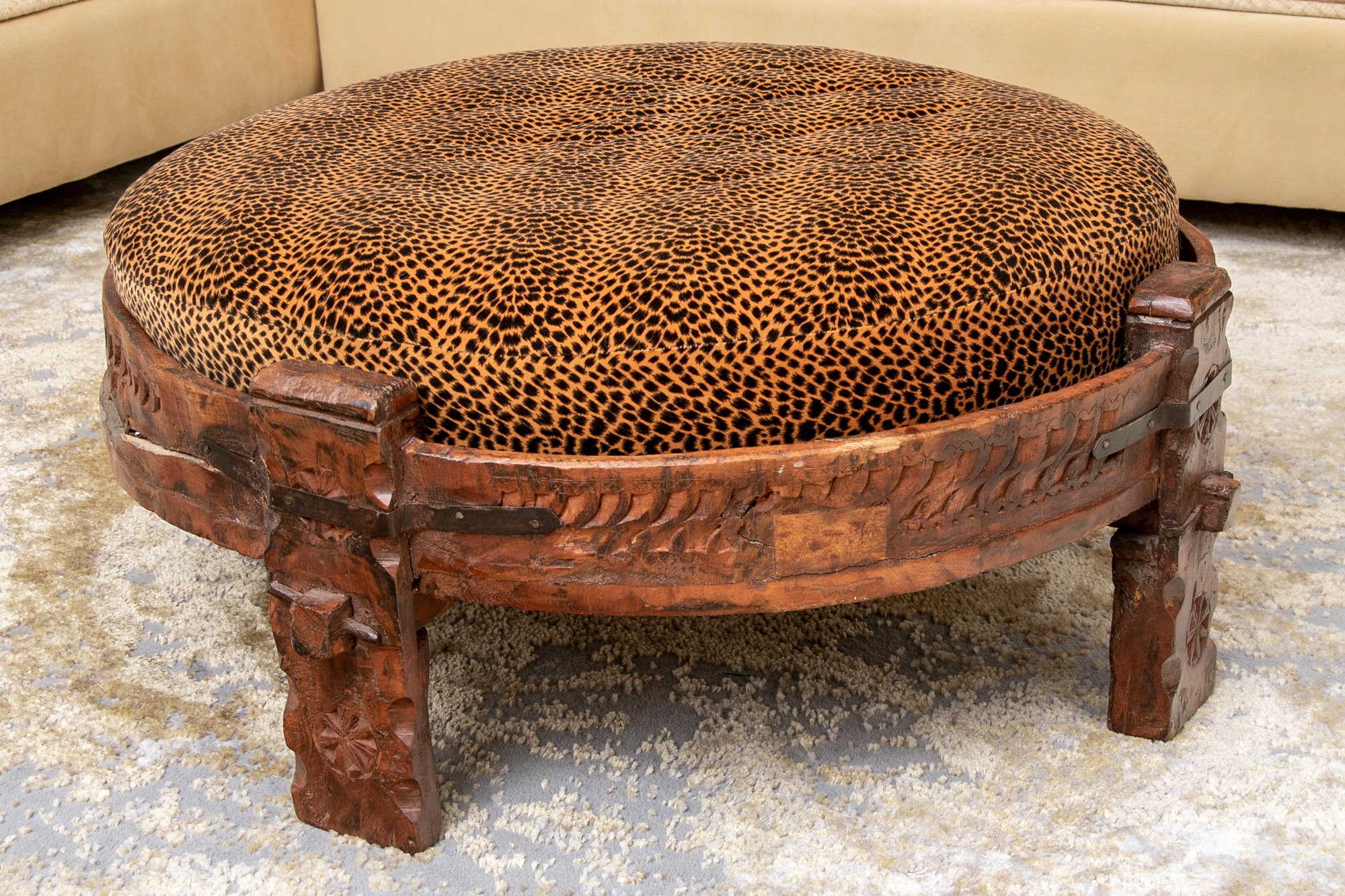 Large carved wood round ottoman with upholstered leopard