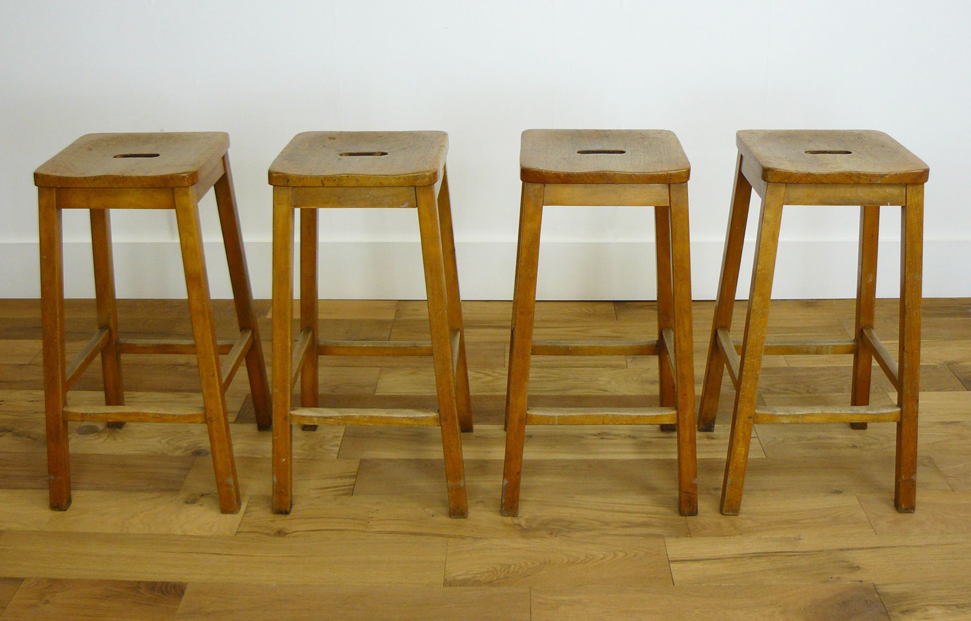 Set of four genuine vintage wooden science lab stools