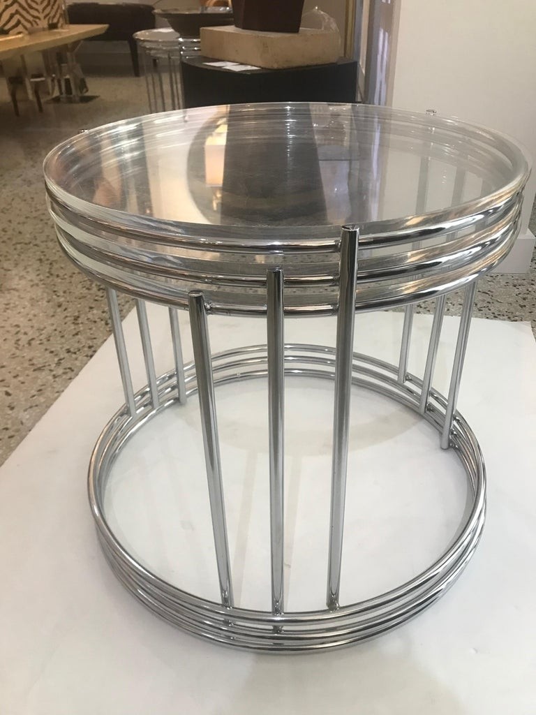 Set of three round polished chrome nesting tables for
