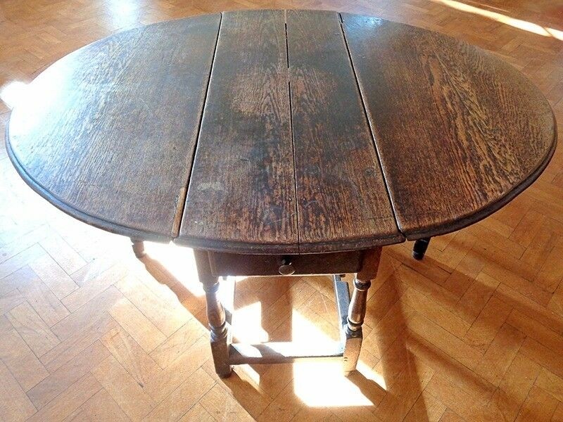 Antique oak oval shaped drop leaf folding table in