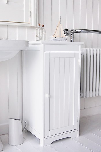 White freestanding bathroom storage with knob handle cabinet