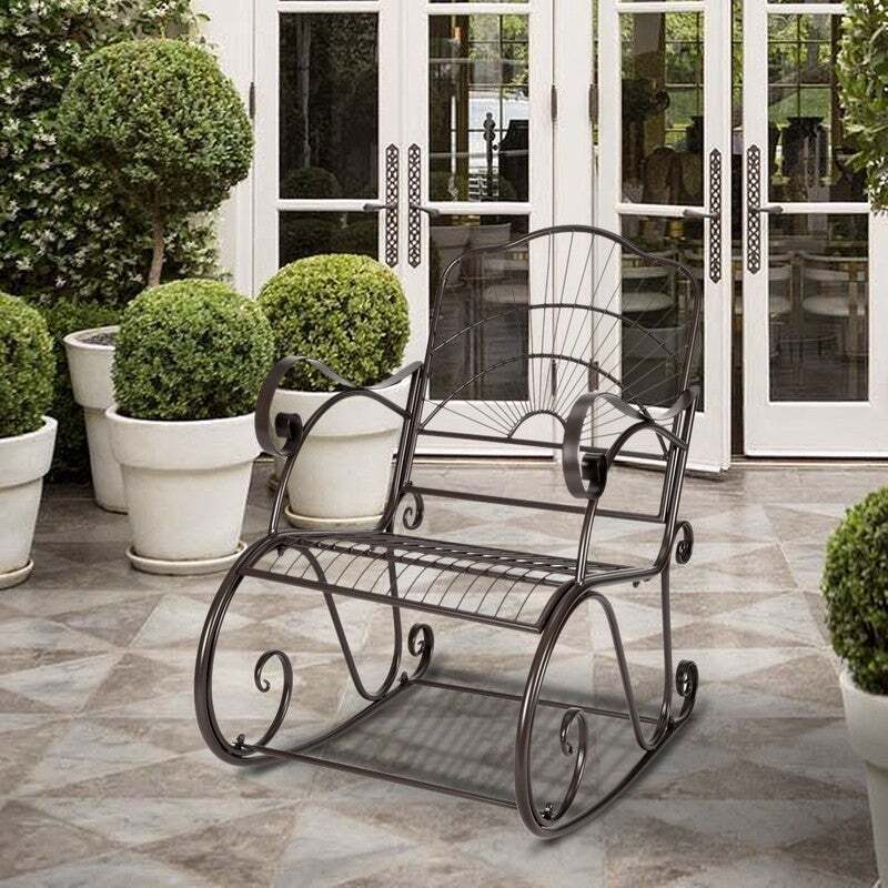 A rocking chair made out of wrought iron for patio furniture