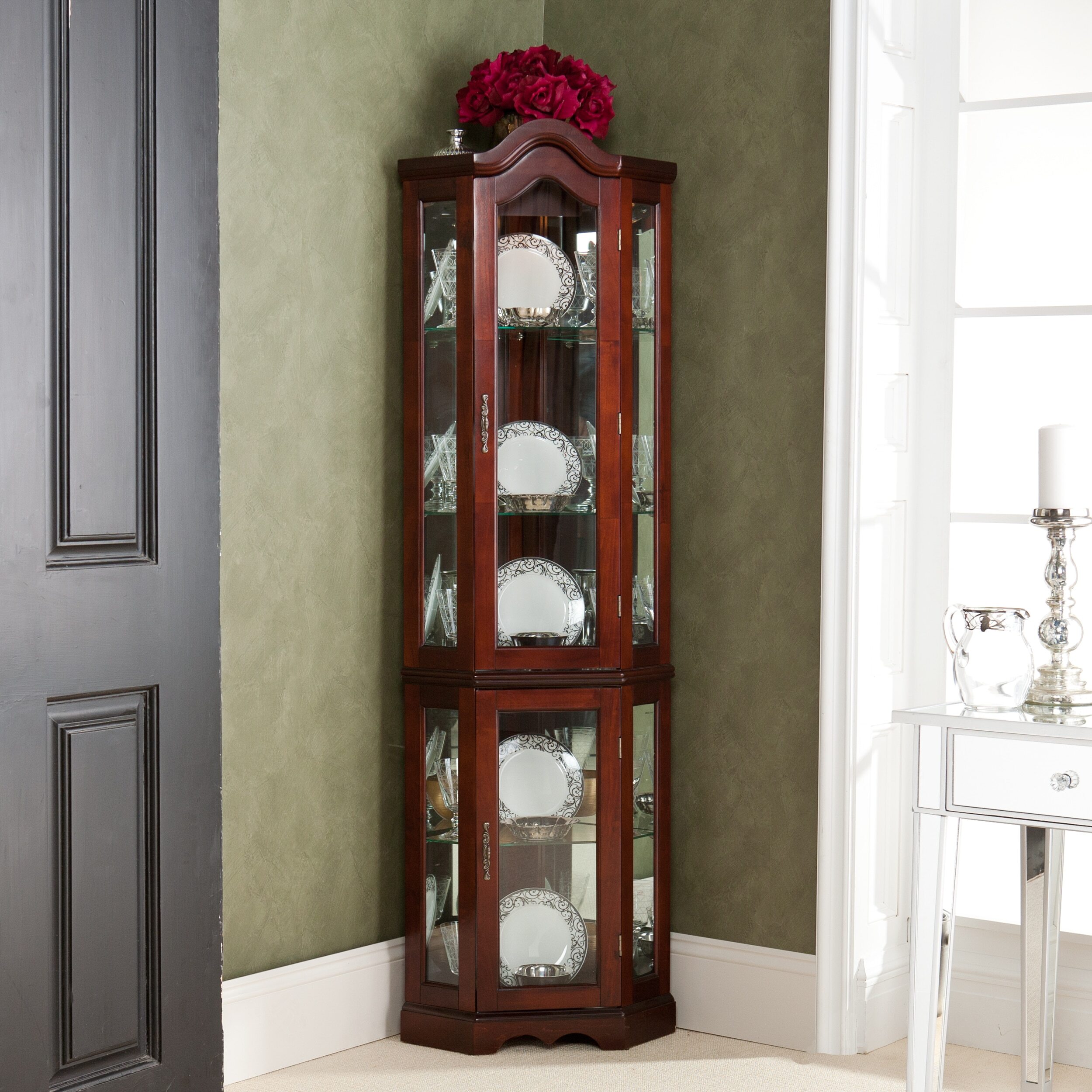 A traditional dark wood dining room corner cabinet 