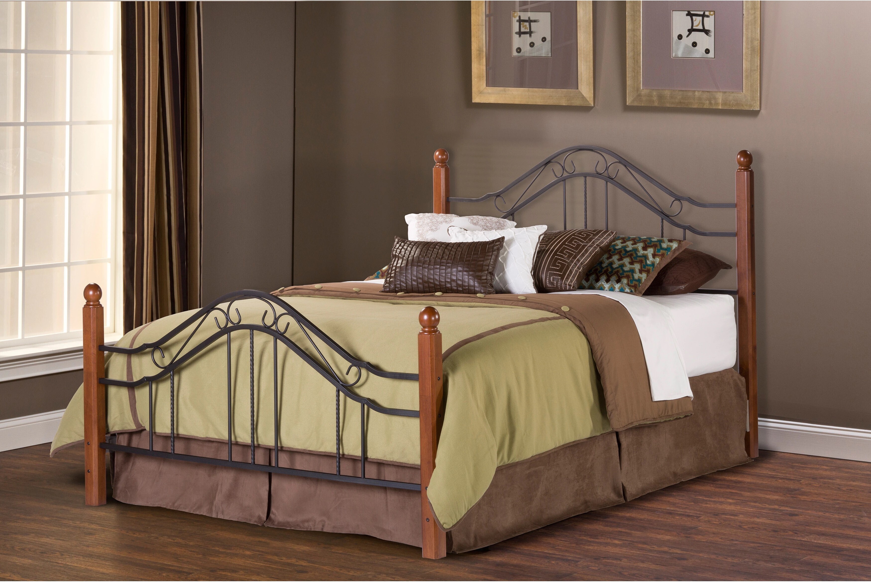 A wrought iron bed frame with sturdy wooden posts