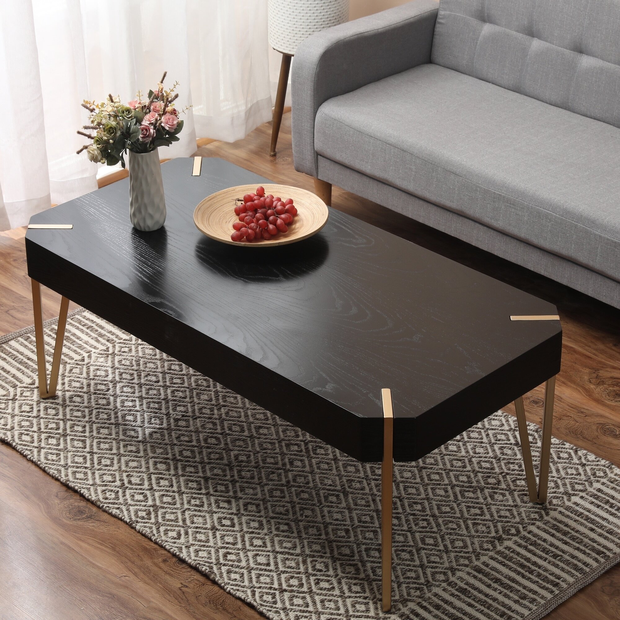 Dark wooden coffee table with gilded metal legs