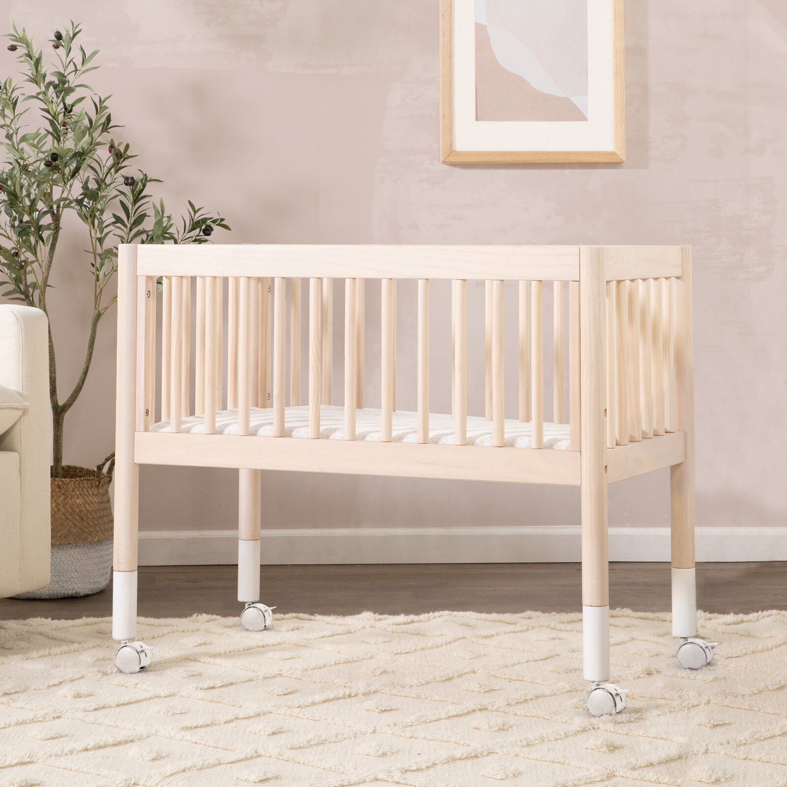 Light colored wooden bassinet for small rooms
