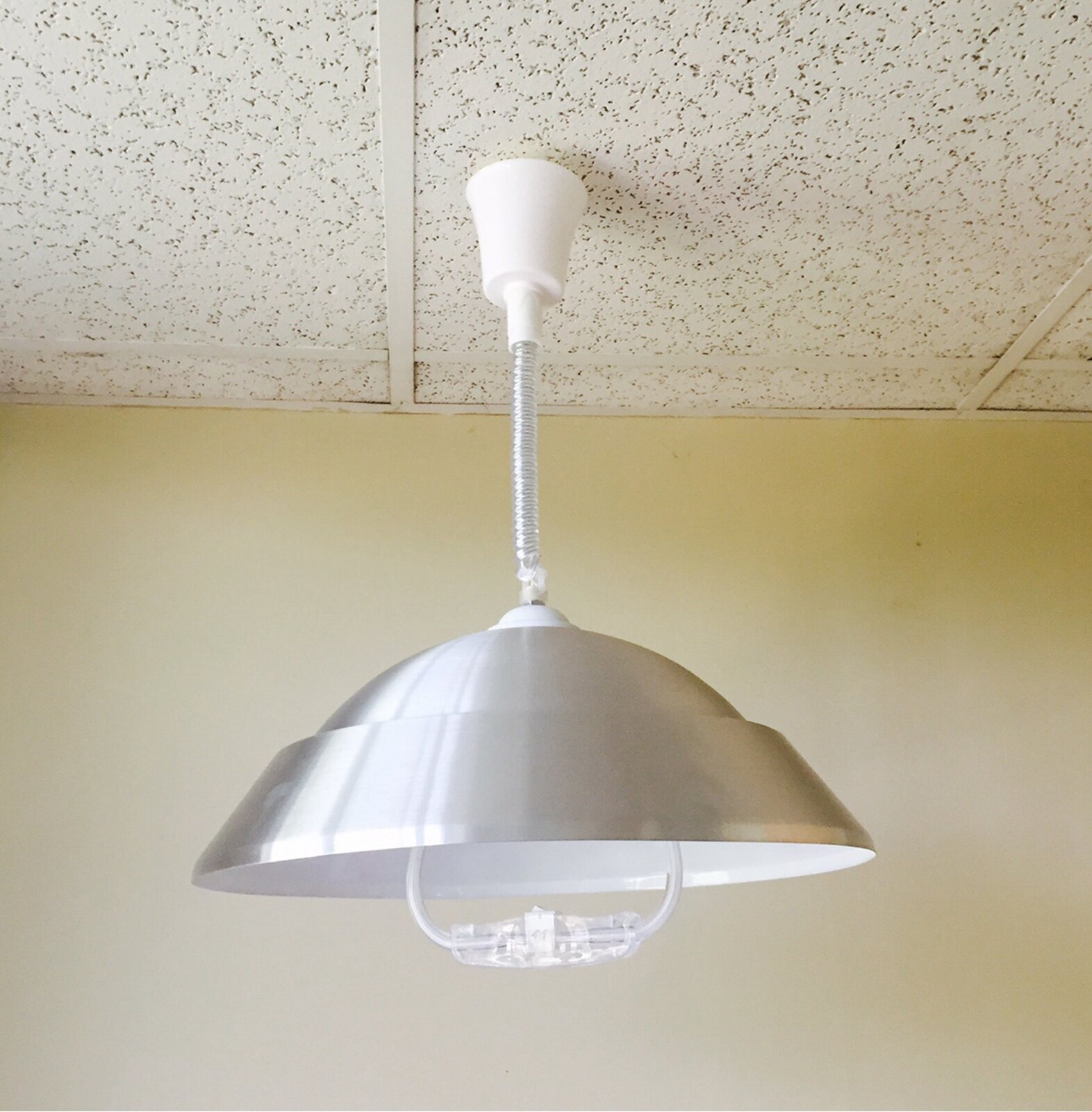 Neutral, domed retractable ceiling light with adjustable height
