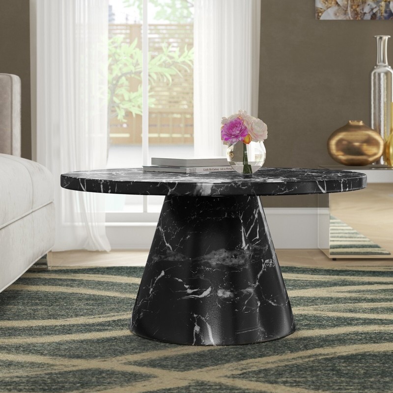 Round black marble coffee table with a pedestal