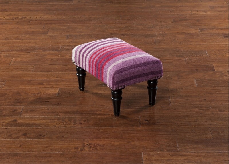 Small footstool with legs in a different material